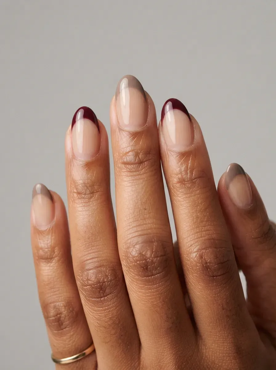 Short almond nails with taupe and burgundy mismatched French tips
