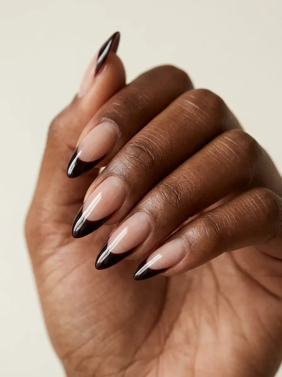 Sheer nude almond nails with dark cherry vampire-inspired French tips